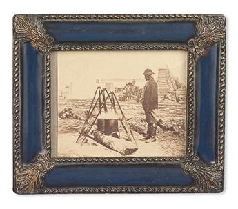 (MILITARY--CIVIL WAR--PHOTOGRAPHY.) African American camp cook, tending a pot, probably that days lunch.